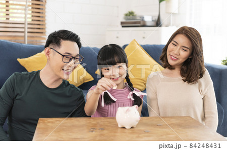 Happy Asian family saving money in piggy bank pig. investment for future concept. Happy Asian family saving money in piggy bank pig. investment for future concept. 84248431