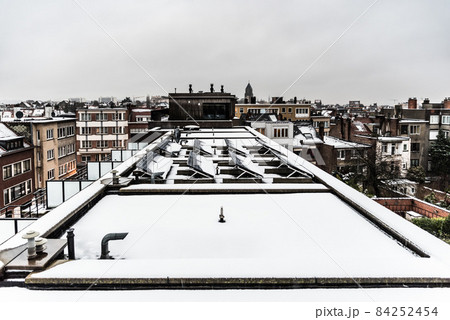 Jette, Belgium , 12 18 2017: view over old and new residential roofs, covered with snow 84252454