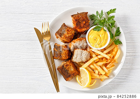fried pieces of hake on a plate with french fries fried pieces of hake on a plate with french fries 84252886