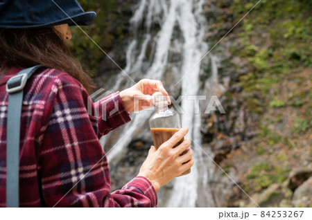 紅葉の滝を見て休憩するミドル女性 84253267