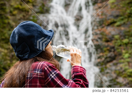 紅葉の滝で休憩するミドル女性 84253561