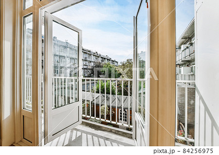 Open doors leading to a balcony with a beautiful view 84256975
