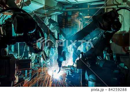Welding robots movement in a car factory Welding robots movement in a car factory 84259288