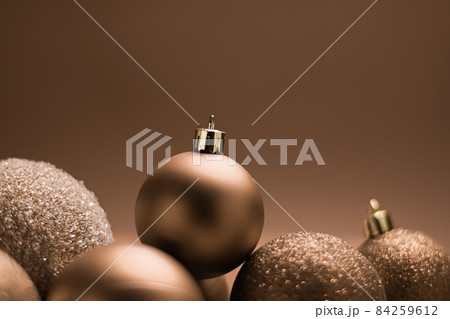Christmas holiday and festive decoration concept. Golden baubles on beige background 84259612