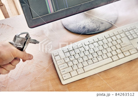 Cleaning a dusty keyboard with a compressed air gun 84263512