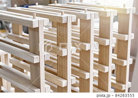 Wine rack of solid oak in the workshop closeup Wine rack of solid oak in the workshop closeup 84263555