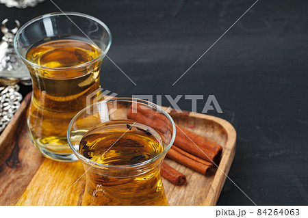Turkish gllass cup of tea served with desserts on table Turkish gllass cup of tea served with desserts on table 84264063