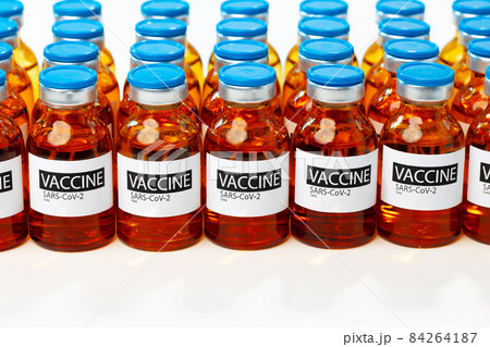Sars-cov-2 vaccine vial bottles on white table Sars-cov-2 vaccine vial bottles on white table 84264187