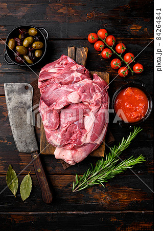 Fresh and raw meat Lamb or mutton, with ingredients and herbs, on old dark wooden table background, top view flat lay 84264841