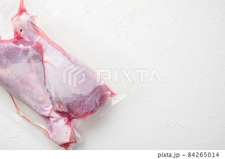 Poultry vacuum packed pack, top view flat lay, with copy space for text, on white stone table background Poultry vacuum packed pack, top view flat lay, with copy space for text, on white stone table background 84265014