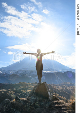 Hiker young woman enjoys nature on top of a mountain 84266389