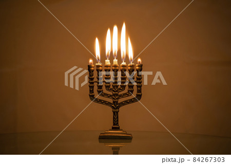 Hanukkah menorah closeup with burning candles for holiday card background. Retro old style hanukkah Hanukkah menorah closeup with burning candles for holiday card background. Retro old style hanukkah 84267303