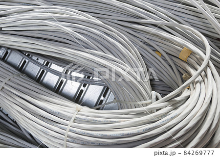 bunch of network cables in wave pattern leading across server ro 84269777
