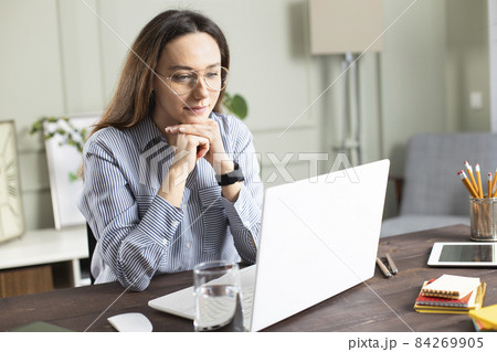 Businesswoman working with laptop at home Businesswoman working with laptop at home 84269905
