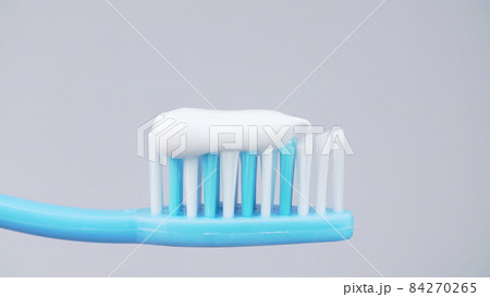Photo of squeezed toothpaste on toothbrush on white background 84270265