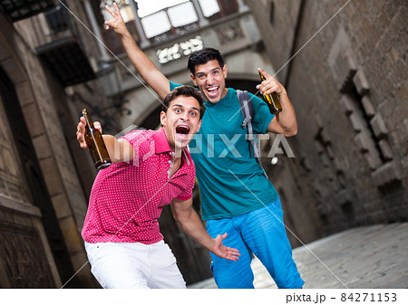 two male fans who are walking with beer 84271153