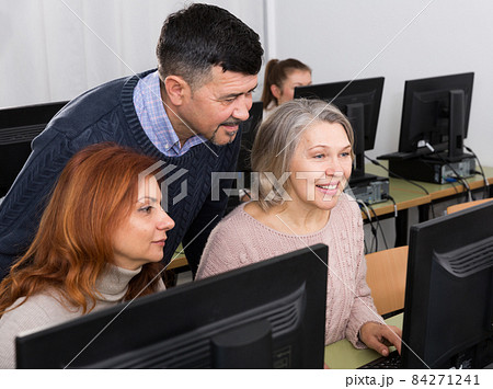 Mature people working together on computer Mature people working together on computer 84271241