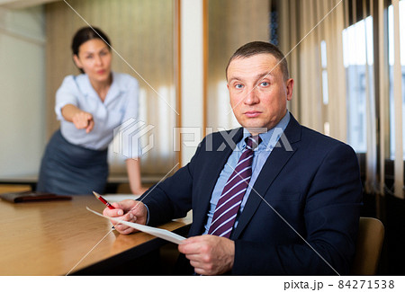 Woman boss firing upset adult male employee Woman boss firing upset adult male employee 84271538