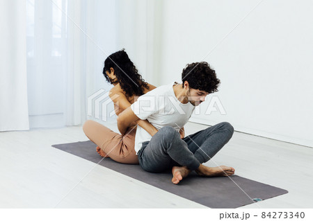 a man and a woman engaged in paired gymnastics yoga asana a man and a woman engaged in paired gymnastics yoga asana 84273340