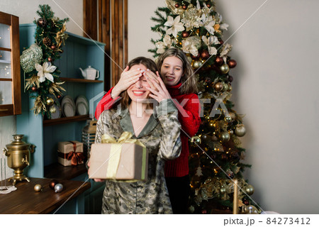 Lesbian couple together indoors cheerfully communicate, preparing for celebration of Christmas. 84273412