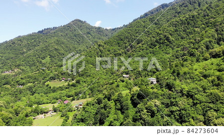 flying drone over green mountains with trees landscape, top view from above, aerial shot, inspirational wonderful nature flying drone over green mountains with trees landscape, top view from above, aerial shot, inspirational wonderful nature 84273604