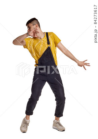 Full-length portrait of a funny guy dancing in studio isolated on white background. Full-length portrait of a funny guy dancing in studio isolated on white background. 84273617