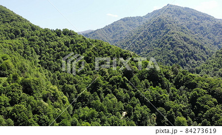 flying drone over green mountains with trees landscape, top view from above, aerial shot, inspirational wonderful nature flying drone over green mountains with trees landscape, top view from above, aerial shot, inspirational wonderful nature 84273619