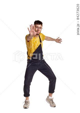 Full-length portrait of a funny guy dancing in studio isolated on white background. Full-length portrait of a funny guy dancing in studio isolated on white background. 84273620
