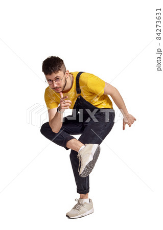 Full-length portrait of a funny guy dancing in studio isolated on white background. Full-length portrait of a funny guy dancing in studio isolated on white background. 84273631