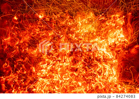 Top above overhead detail view od abstract hot red burning wooden coal background in bbq grill brazier or firepit at dark night time. Beautiful inferno heat sparks glowing flaming at hearth stove Top above overhead detail view od abstract hot red burning wooden coal background in bbq grill brazier or firepit at dark night time. Beautiful inferno heat sparks glowing flaming at hearth stove 84274083