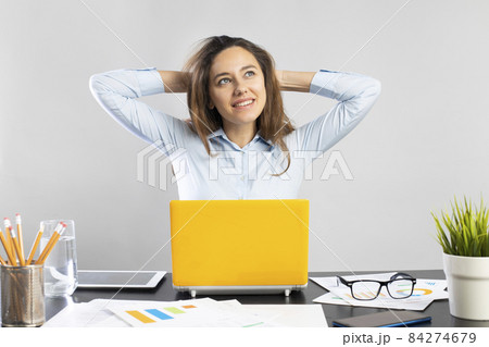 Businesswoman relaxing at office Businesswoman relaxing at office 84274679