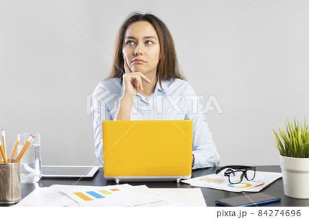 Confused thoughtful young business woman Confused thoughtful young business woman 84274696