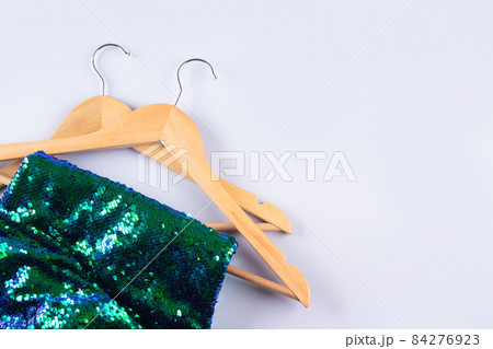 Fashion sequins fabric on hangers on gray background with copyspace. Conscious and environmentally friendly consupmtion - clothing rental service. Slow fashion concept. Fashion clothes for rent 84276923