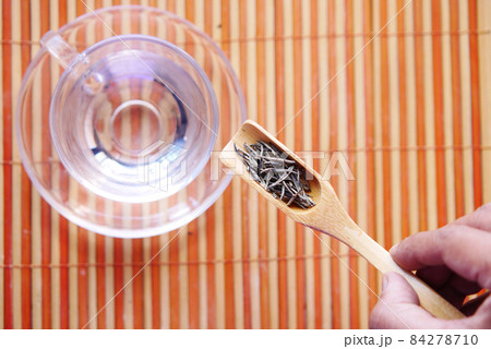 Dry tea leaves on spoon close up . Dry tea leaves on spoon close up . 84278710