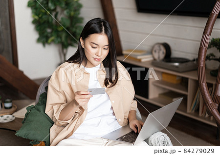 Portrait of korean woman shops online, buying on website with laptop and credit card, purchase course or membership Portrait of korean woman shops online, buying on website with laptop and credit card, purchase course or membership 84279029