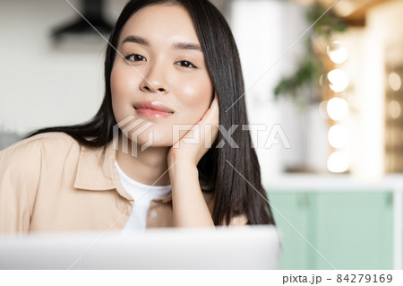 Portrait of asian smiling woman with laptop at home 84279169