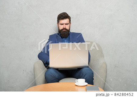 Businessman work laptop. Man drink coffee in business  84280452