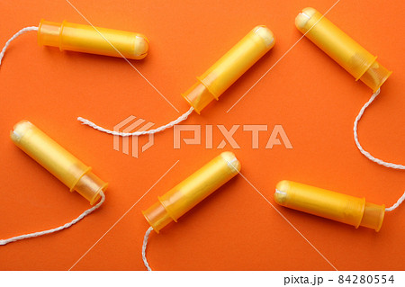 Women tampons on orange background, top view 84280554