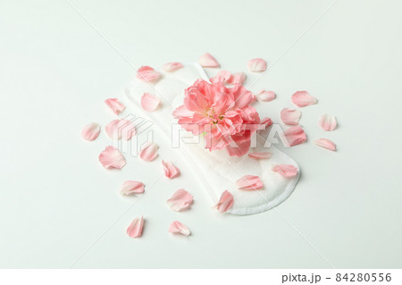 Hygiene pad with flower and petals on white background Hygiene pad with flower and petals on white background 84280556