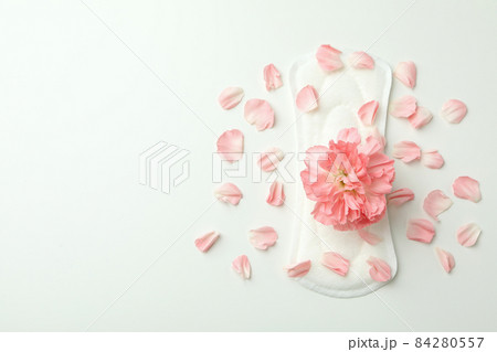 Hygiene pad with flower and petals on white background Hygiene pad with flower and petals on white background 84280557