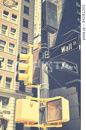 Traffic lights pole with Wall Street and Water Street in downtown New York, retro color toning applied, USA. Traffic lights pole with Wall Street and Water Street in downtown New York, retro color toning applied, USA. 84281202