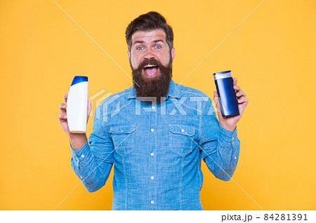 Grooming at every opportunity. Bearded man hold shampoo care. Grooming products for men Grooming at every opportunity. Bearded man hold shampoo care. Grooming products for men 84281391