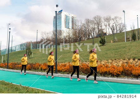 panorama with several images of the same female jogger on a running track against a city background panorama with several images of the same female jogger on a running track against a city background 84281914