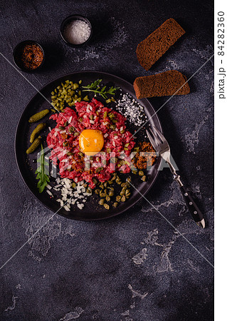 fresh beef tartar with tasty vegetables 84282360