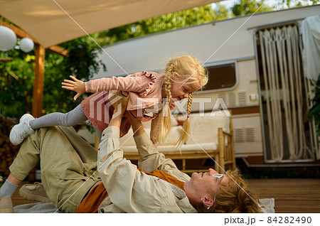 Daddy and gaughter play on terrace at the trailer Daddy and gaughter play on terrace at the trailer 84282490