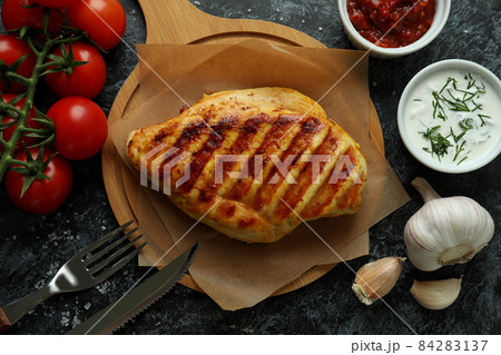 Concept of tasty eating with grilled chicken on black smokey background Concept of tasty eating with grilled chicken on black smokey background 84283137
