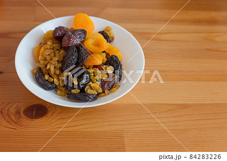 Healthy breakfast and snacks. White plate with dried fruits 84283226