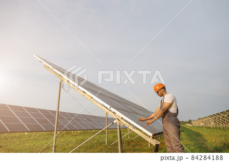 Technician measuring voltage in solar cells outdoors Technician measuring voltage in solar cells outdoors 84284188