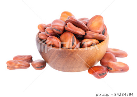 Broad beans in wooden bowl, isolated on white background. Dry fava beans. Broad beans in wooden bowl, isolated on white background. Dry fava beans. 84284594
