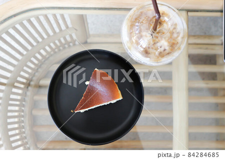 cheesecake or basque cheesecake , piece of cake and iced coffee 84284685